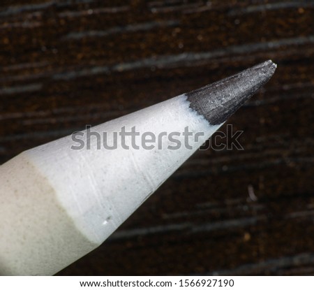 white color drawing pencil on dark background Royalty-Free Stock Photo #1566927190