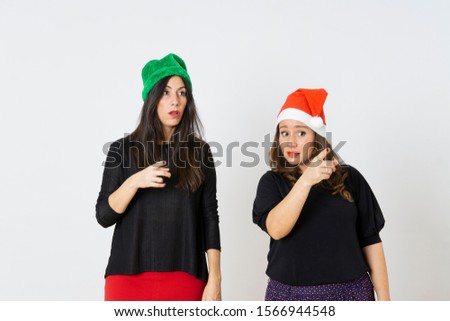 Young pretty women wearing funny red horns. making funny gestures Christmas concept. Santa claus time