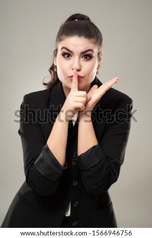 Worried businesswoman making silence sign