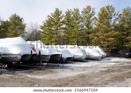 Recreational boats shrink wrapped for the winter at the marina on Fox River Royalty-Free Stock Photo #1566947104