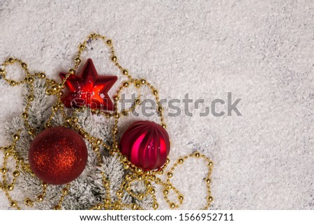 Christmas tree decorations, red balls and star on a white snowy background. Background, texture as an idea. View from above