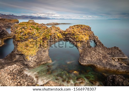 Iceland's Famous basalt Stone Arch Gatklettur in Western coastal sea.