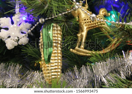 Happy New Year 2020. Abstract background photo of coming New Year. Golden and silver Christmas decorations on a tree.Golden corn and horse.