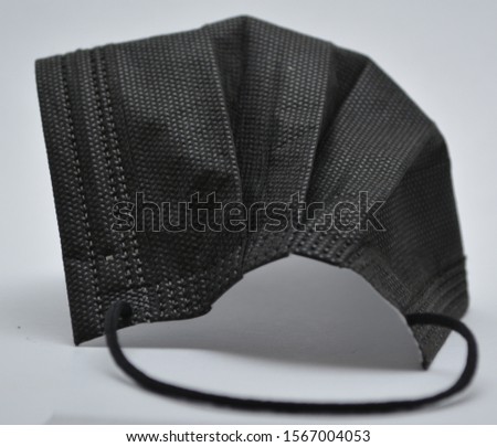 Close-up of 3-layer folded facemask with elastic straps