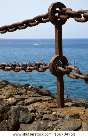rusty chain  water  boat yacht coastline and summer in lanzarote spain 