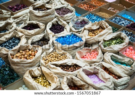 Beads, stones, and various plastic materials to choose from to make necklaces and bracelets.