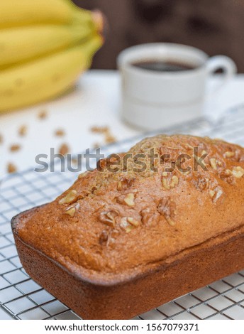 Freshly baked healthy banana and walnut bread loaf on a wire rack