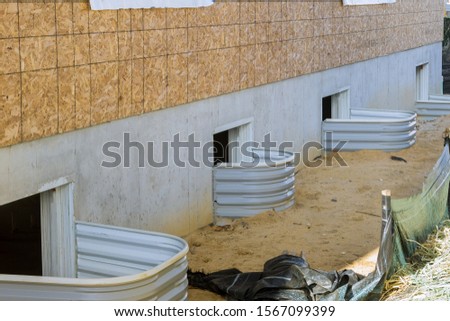 New house under construction window well craft basement construction Royalty-Free Stock Photo #1567099399