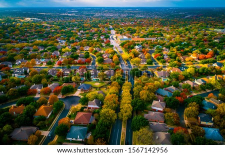 roads leas to suburbia fall Autumn suburb suburbia round Rock Texas colorful landscape trees changing colors fall in central texas  Royalty-Free Stock Photo #1567142956