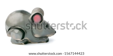 One Piggy Bank in the form of a gray mouse, a rat sitting sideways on a white background. Banner