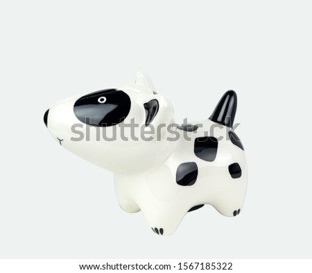 Black and white striped dog doll left side, made of ceramic. Isolated on white background. Close up shot. With clipping paths.