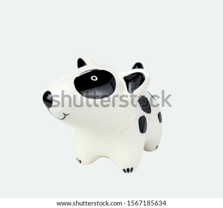 Black and white striped dog doll front side, made of ceramic. Isolated on white background. Close up shot. With clipping paths.