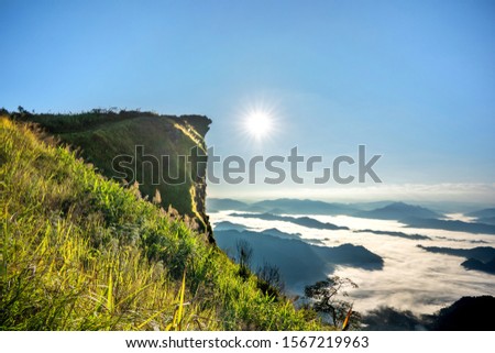 Scenic Panorama picture or postcard view of layer mountain,Blue sky and sunrise background at Phu Chi Fa,Thailand.Beautiful nature outdoor scene landscape.Vacation Holiday. 