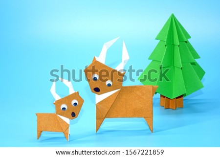 Origami Christmas paper art : Reindeer and Christmas tree, Merry Christmas and Happy New year. Copy space