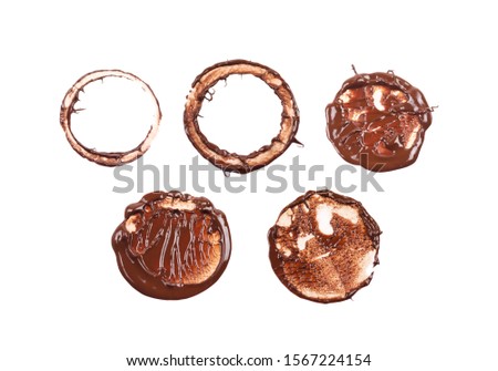 Set of chocolate stamp in circle and ring shapes. Dessert presentation. Round shape chocolate sauce, ganache, gravy. Top view photo isolated on a white background.