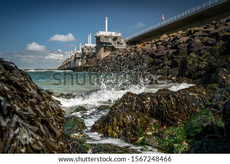 View at Dutch storm barrier Oosterscheldekering in Zeeland, This Delta Work of dams is designed to protect the Netherlands from flooding from the North Sea Royalty-Free Stock Photo #1567248466