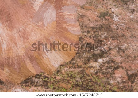 Aerial photography red mud with grass shrub texture background top view