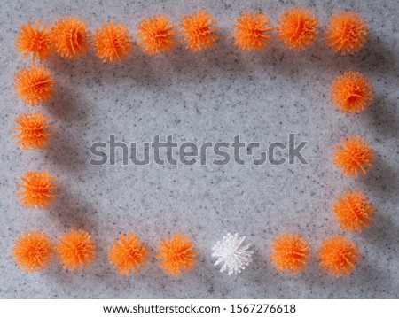 The rectangular-shaped original photo frame, made of multi-colored balls-burdocks of a child’s Velcro designer, casting a shadow on a gray background with a texture of artificial stone - granite.