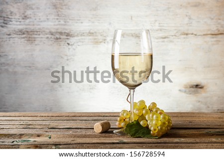 Glass of white wine on vintage wooden table Royalty-Free Stock Photo #156728594