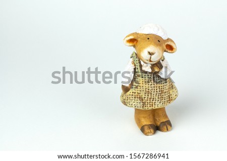 Ceramic  sheep dolls. Ceramic dolls women. isolated on white background. Close up shot. With copy space. 