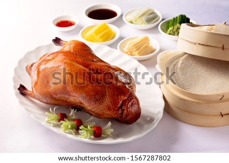 Whole Peking duck served with the sides, sauces and wraps