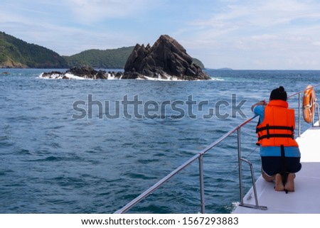 tourist take picture with mobile phone yacht cruise at Phuket, Thailand