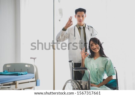 a man doctor and female patient are showing an OK sign a smile and happy with medical service at the clinic