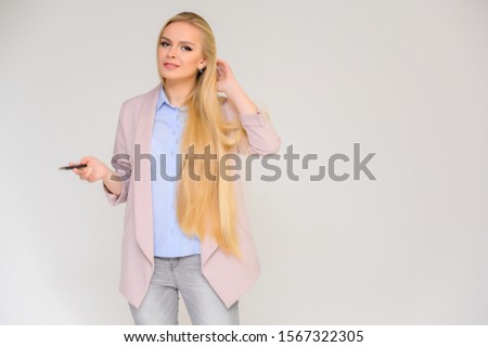 Concept pretty woman talking to camera. Portrait of a beautiful blonde girl with long straight hair standing at the camera in various poses, talks and shows with emotions on a white background.