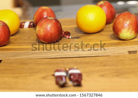 Red apple and orange on a brown wooden board. Group. Stock photo