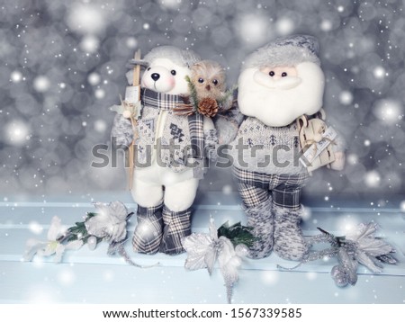 winter christmas background with santa bear decor snow on blue wooden texture                              
