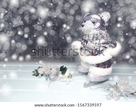 winter christmas background with bear on skates decor snow on blue wooden texture                              