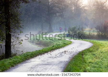 Winding bicycle path along the small river De Loet in the Krimpenerwaard in the Netherlands