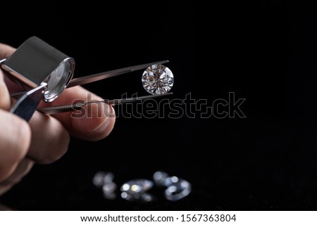 Gem stones. Jeweller checking polished diamond. Carat size diamonds. Diamond trading and dealing. Loose diamond grading. Precious stones. Royalty-Free Stock Photo #1567363804