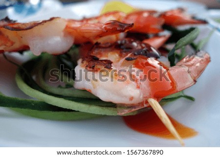 Grilled tasty shrimps with blur effect. Food and ingredients background.                 
