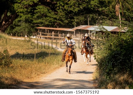 Cowboy riding a horse at camp