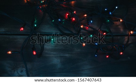 Christmas lights on wooden background. View with copy space. christmas garland