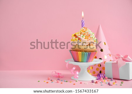Composition with birthday cupcake on pink background. Space for text