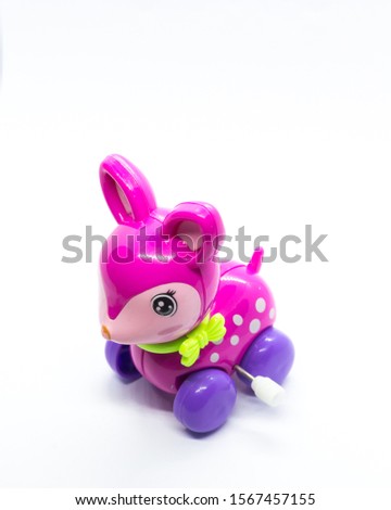 Rabbit miniature toy in front of plain white background