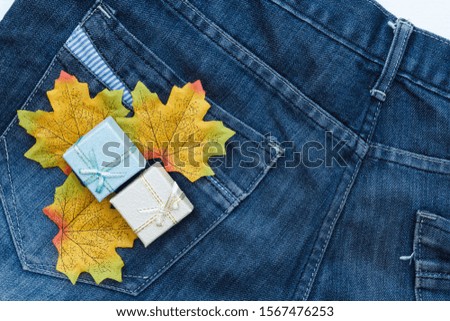 Maple leaf and mini box on the jean background. 