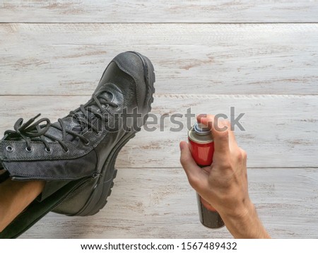 Impregnation of leather boots for winter and moisture. Royalty-Free Stock Photo #1567489432