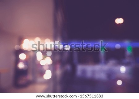 BLURRED OFFICE BACKGROUND WITH LIGHTS REFLECTIONS IN THE WINDOW