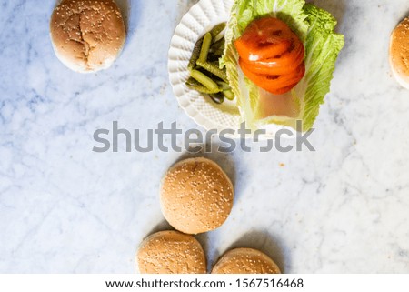hamburger ingredients on a marble table