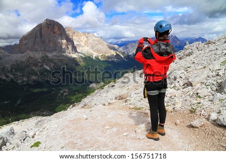 Climber taking pictures of the amazing view, Dolomite Alps, Italy