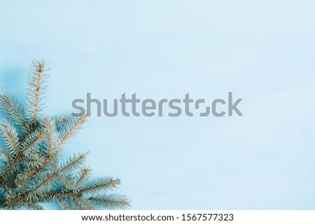 Christmas fir tree on a vintage wooden background with snowflakes. Christmas fir tree branches on old wooden table with bokeh light.