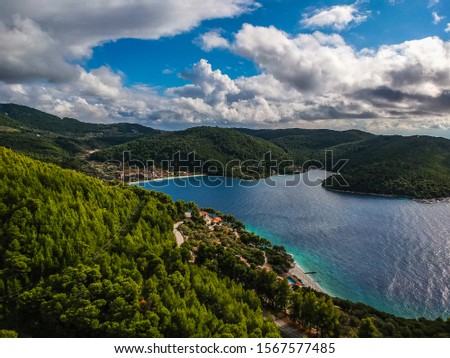 Aerial panoramic view over Milia beach in Skopelos island, against a cloudy sky in Sporades, Greece