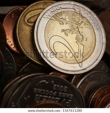 Pile of multiple euro coins. two euro coin. light and shadow. metal money background. 