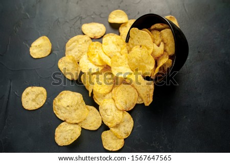 potato chips in a bowl, beer snacks on a stone background Royalty-Free Stock Photo #1567647565