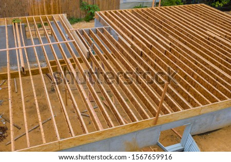 House framing floor construction showing massive solid wood joists trusses Royalty-Free Stock Photo #1567659916