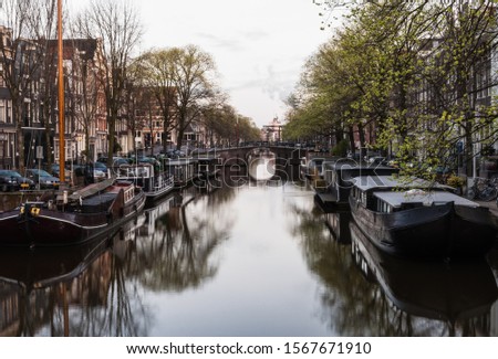 View of Amsterdam canal with boats in the early morning