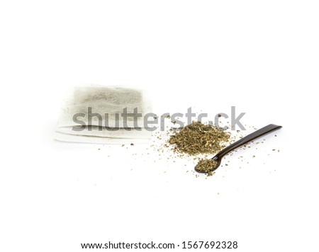 cistus tea with brown spoon on white background and tea bags